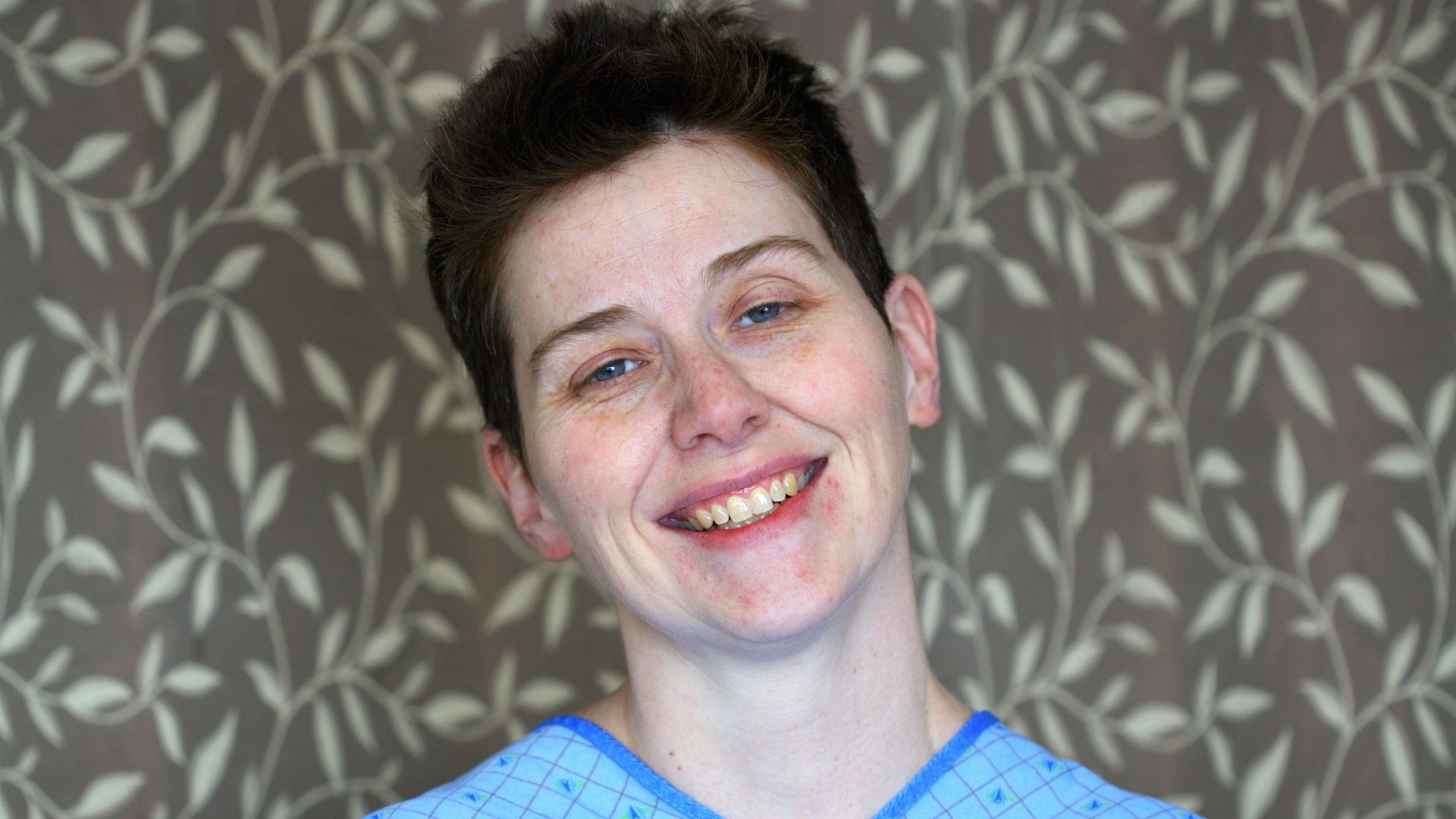 man in blue and yellow sweater smiling