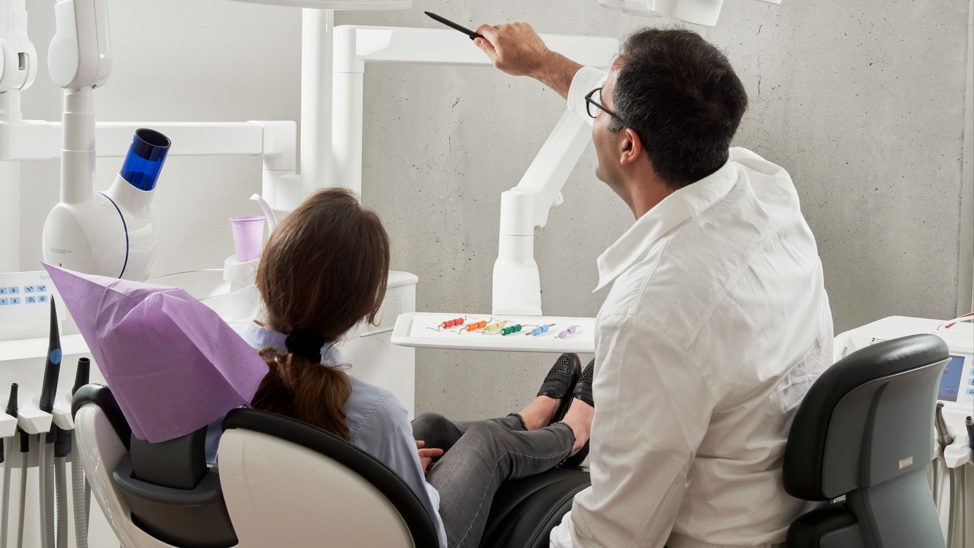man in white dress shirt holding black pen