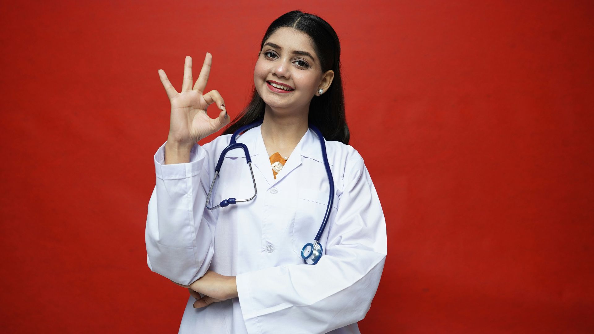a doctor with her hand up