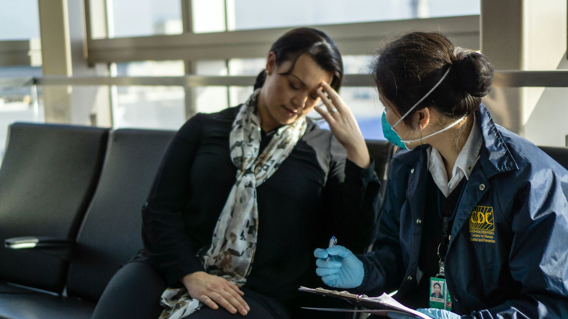 woman in black blazer sitting on black sofa