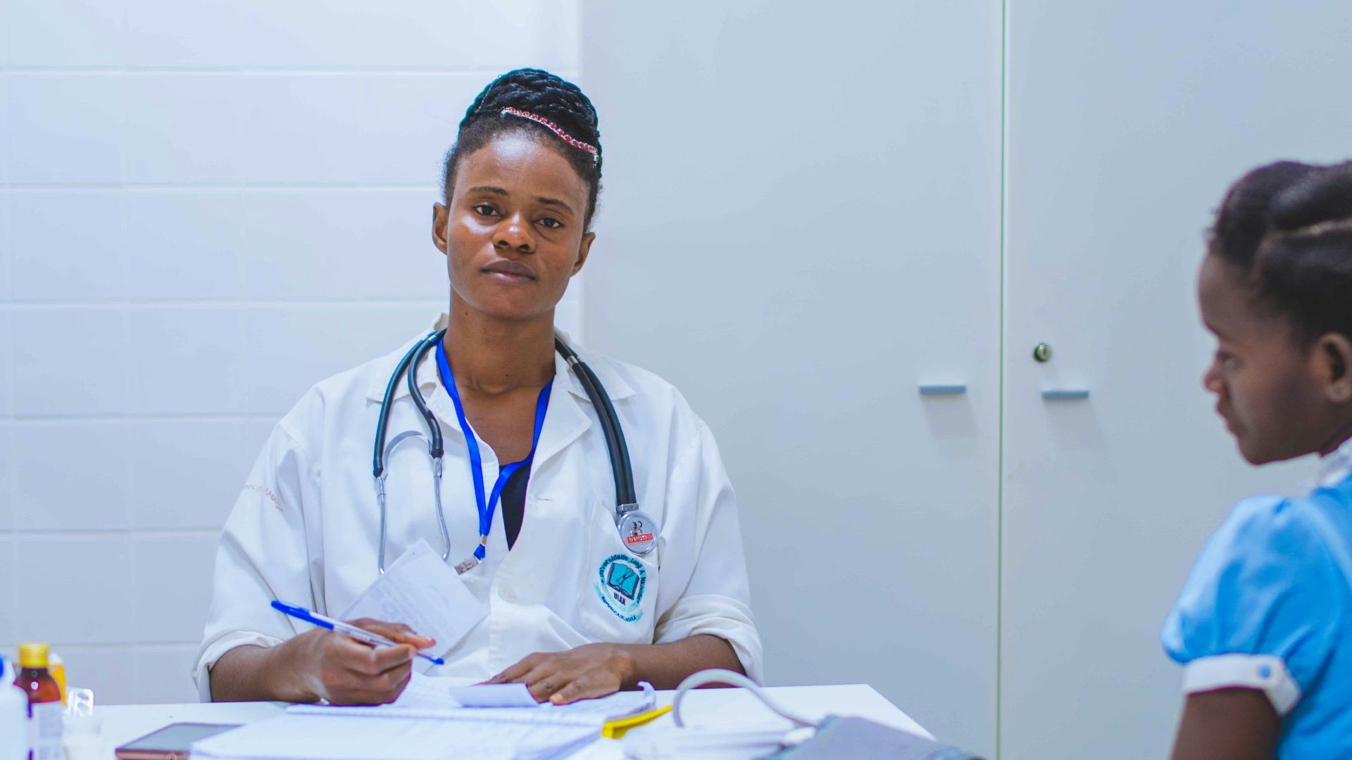 doctor sitting at the table in front of girl