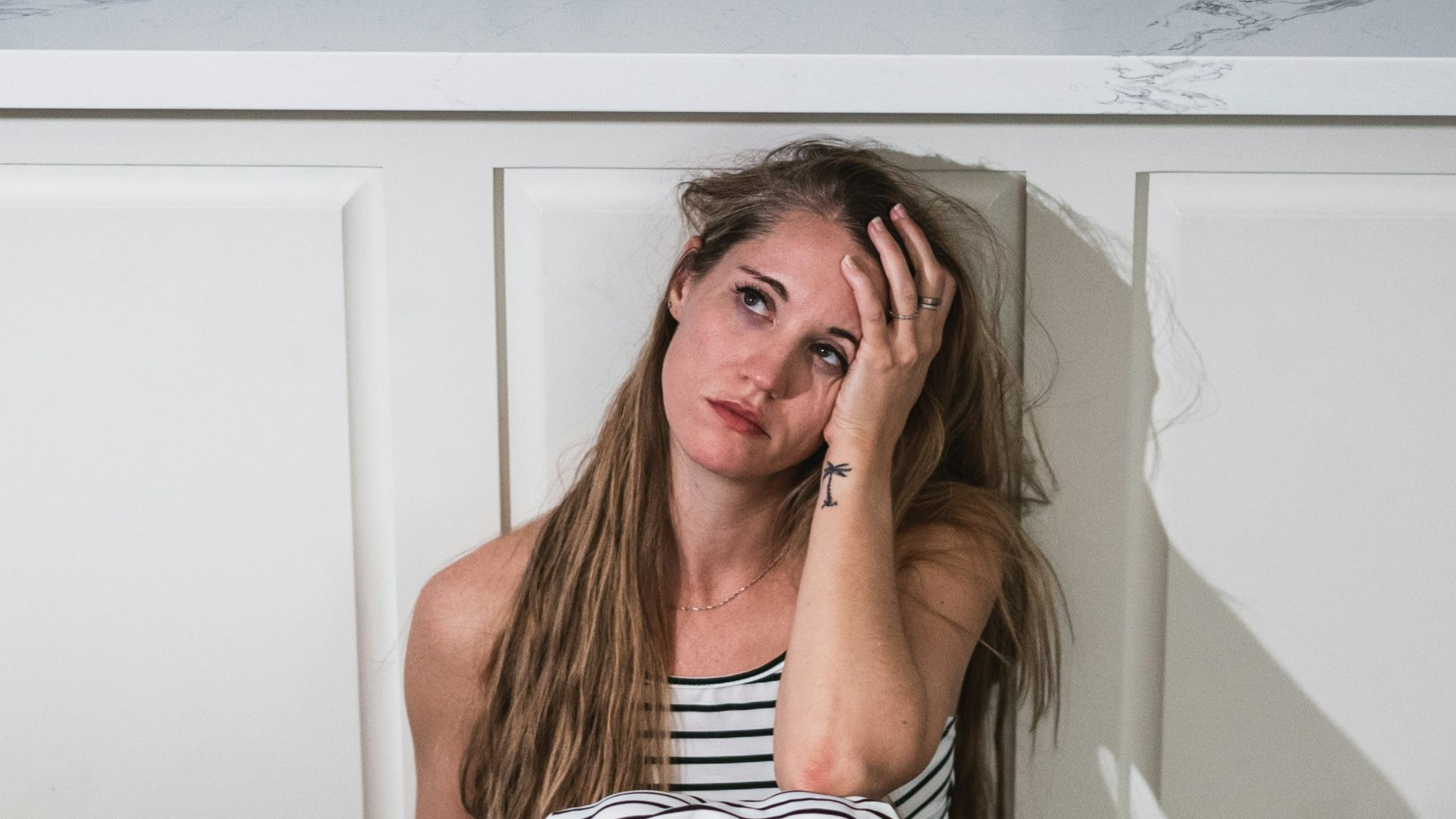 woman in black and white stripe dress holding wine glass