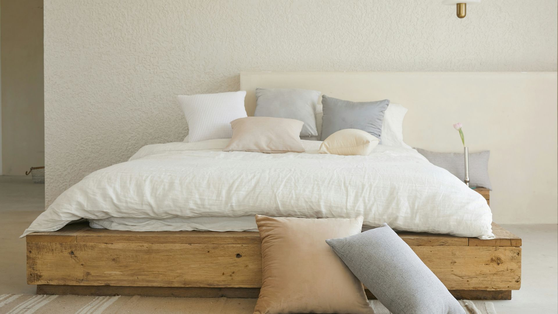 white bed pillow on brown wooden bed frame