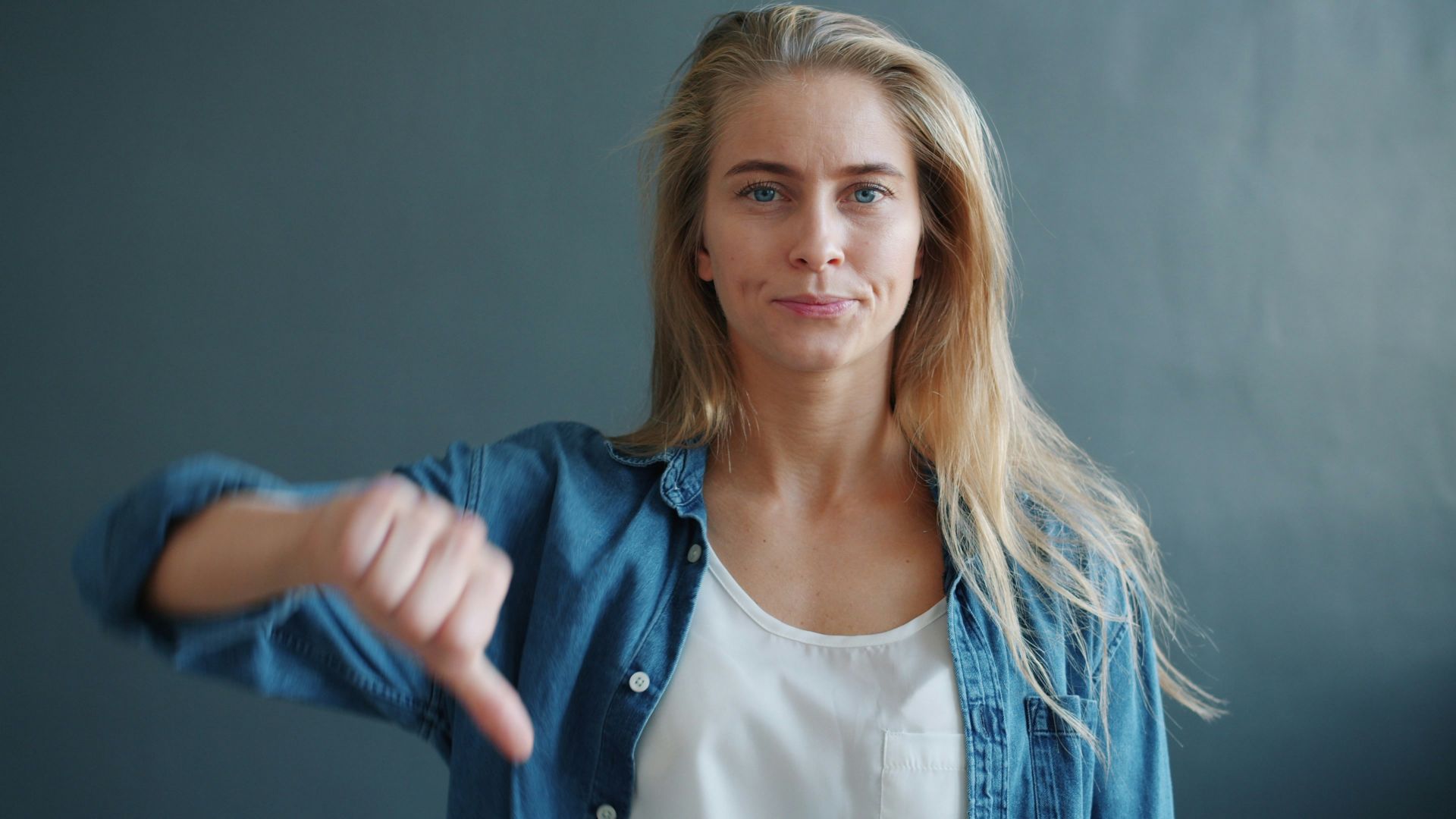 Woman giving a thumbs down gesture