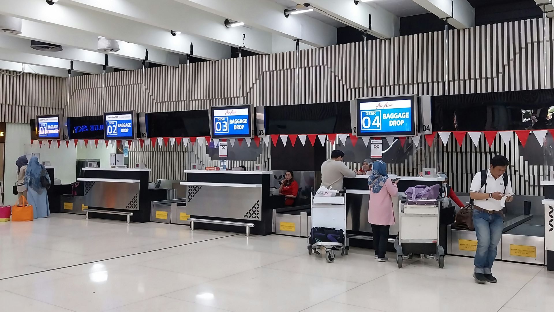 a group of people waiting in line at an airport