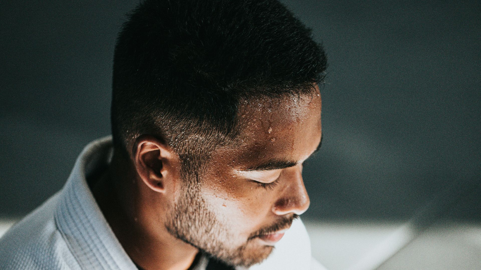 man in white shirt sitting on black chair