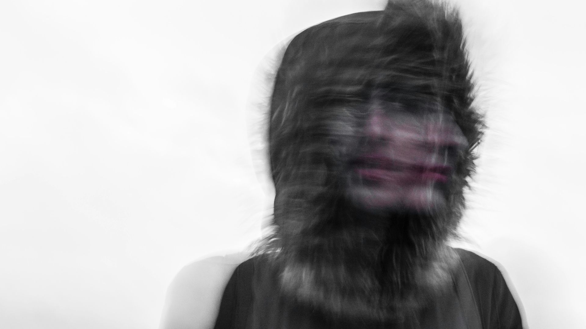 Creepy blurred photo of a person's face and a furry hood