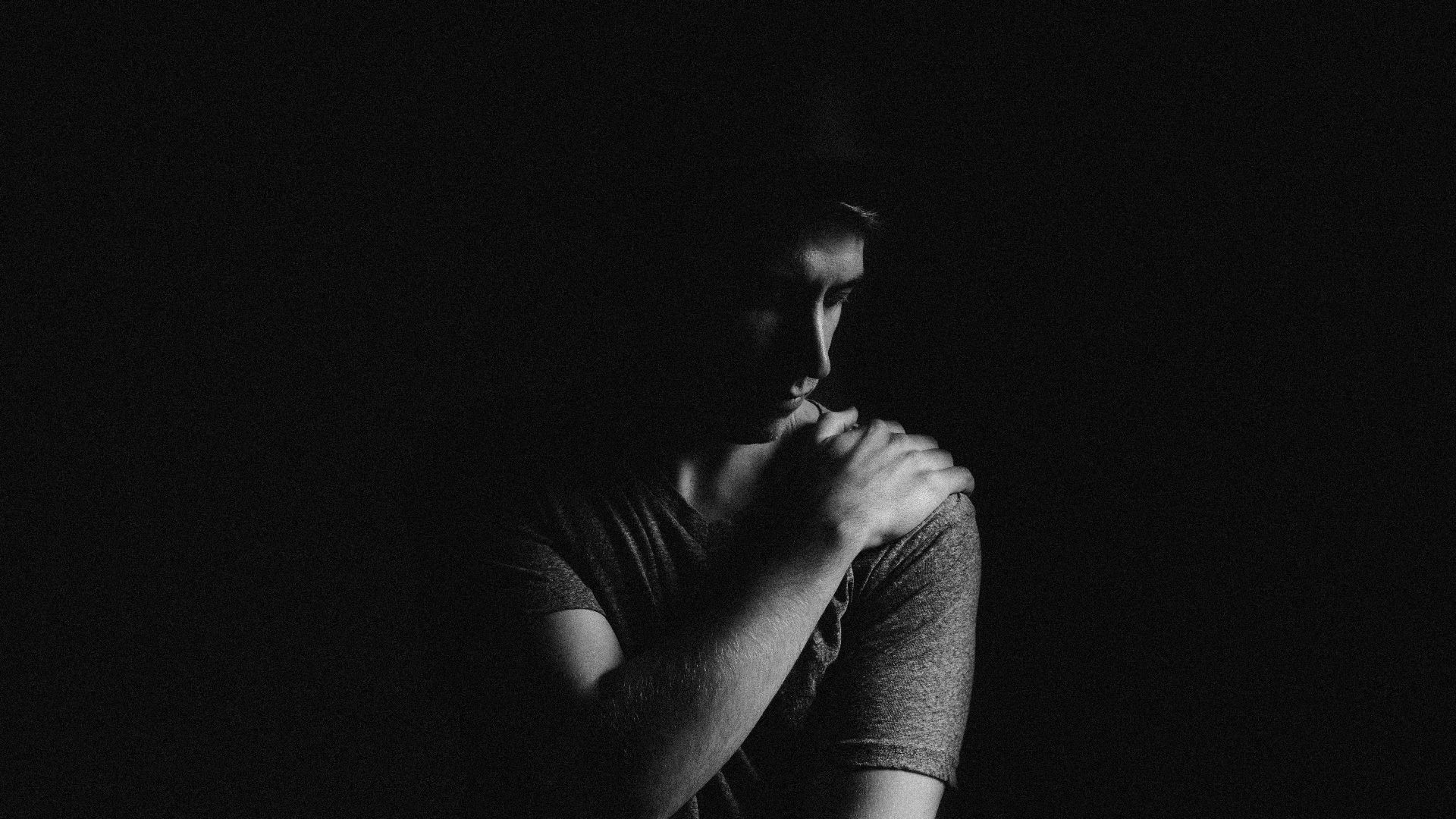 man holding his left shoulder