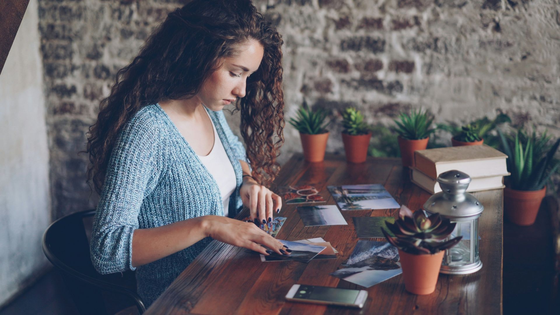 Woman looking at tarot cards on a wooden table