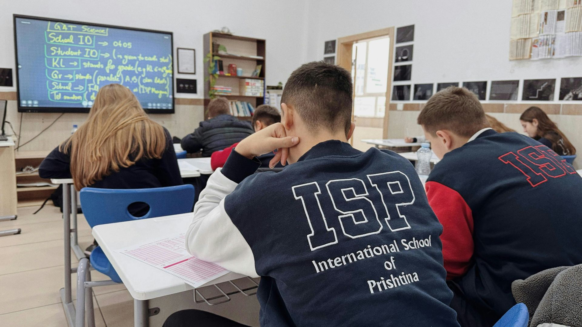 A group of students sitting at desks in a classroom