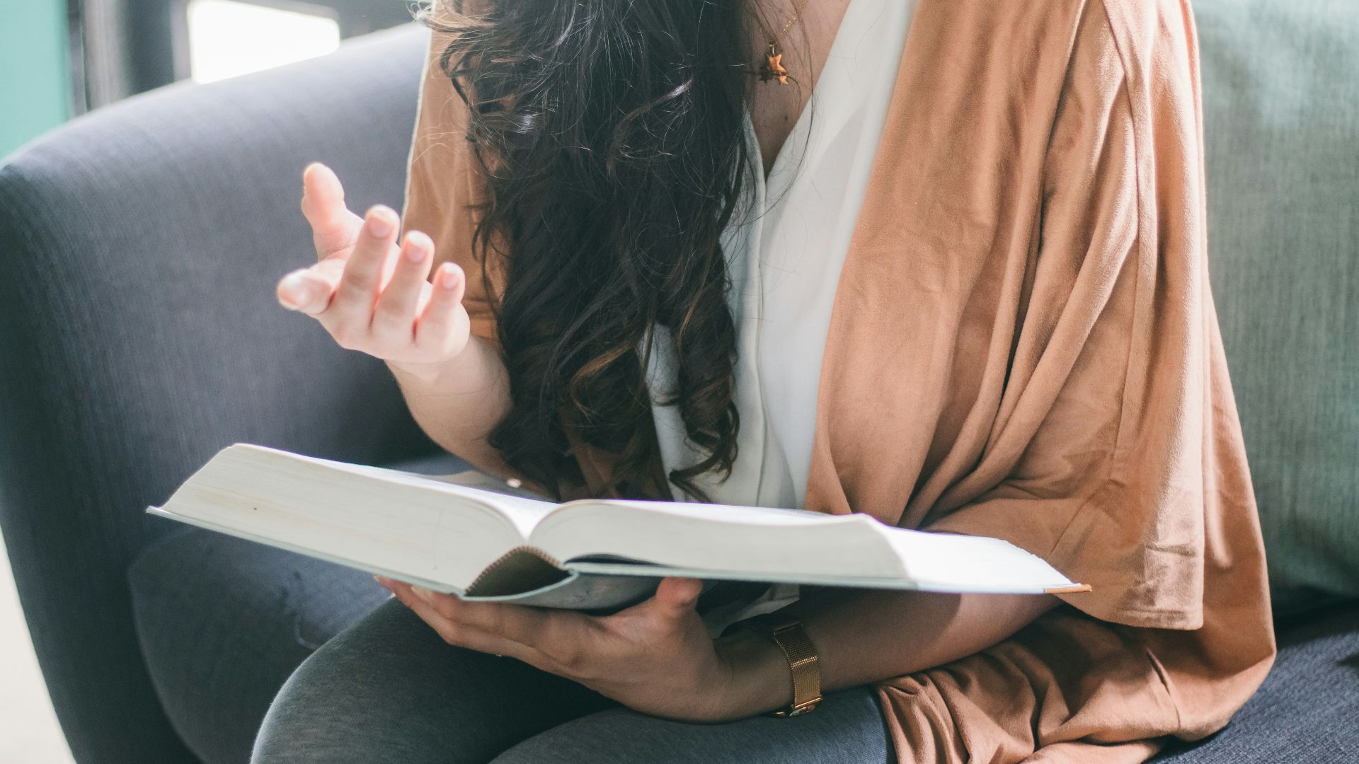 woman in orange blazer sitting on car seat