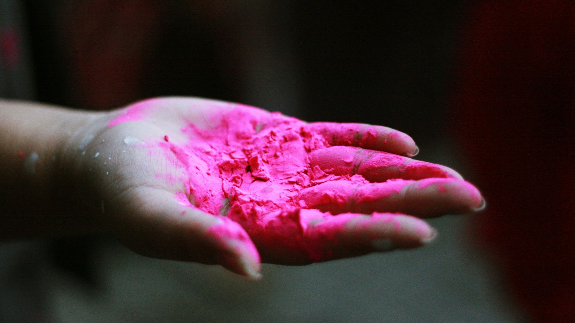 pink powder in right human palm