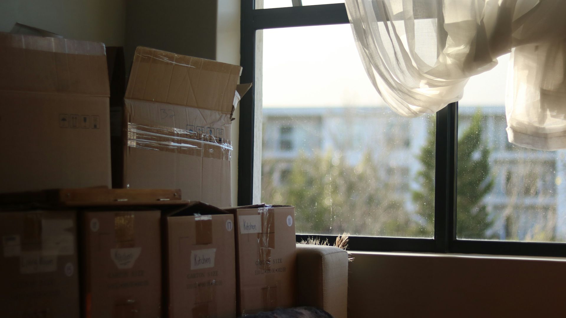 a room with boxes and a window