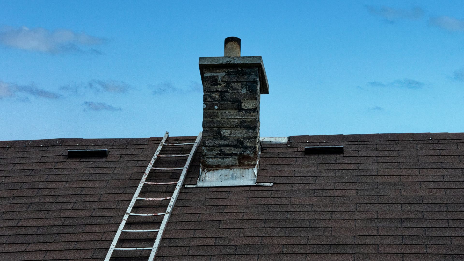 a ladder is on the roof of a house