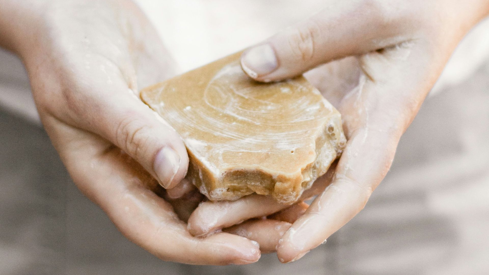 person holding brown stone fragment