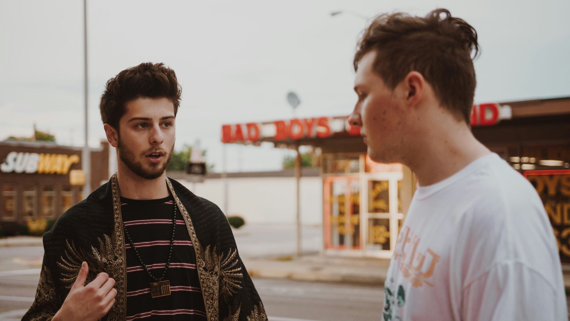 man talking to another man