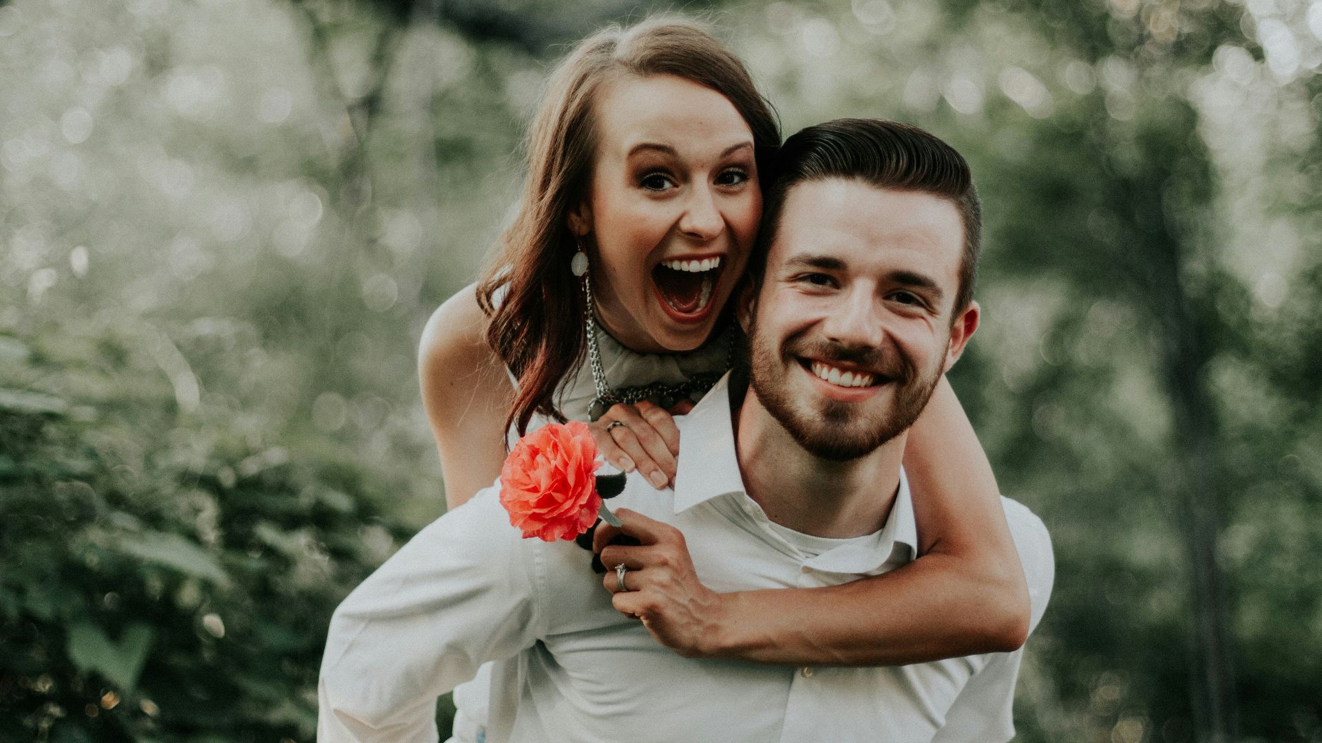 woman riding on back of man