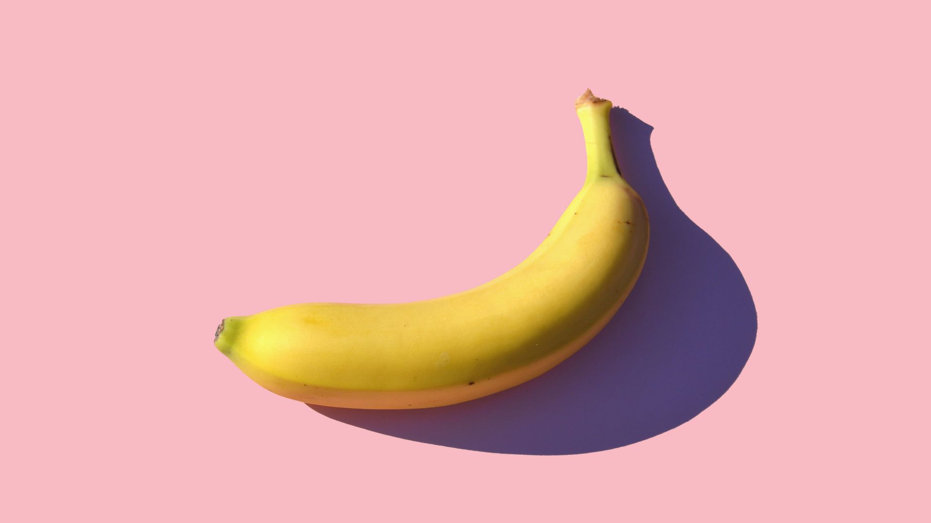 riped banana on pink surface