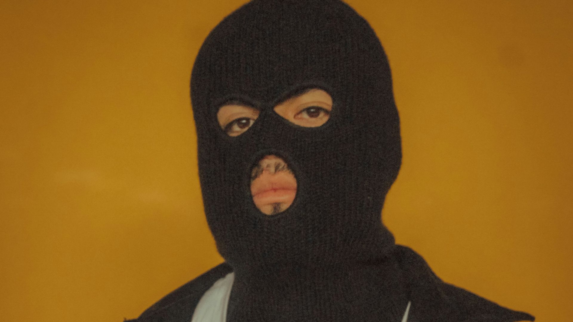 person in black coat wearing white turtleneck shirt