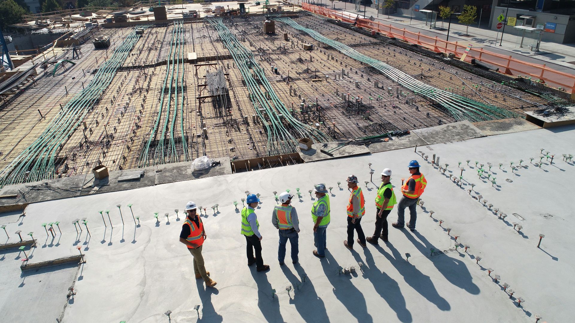 seven construction workers standing on white field