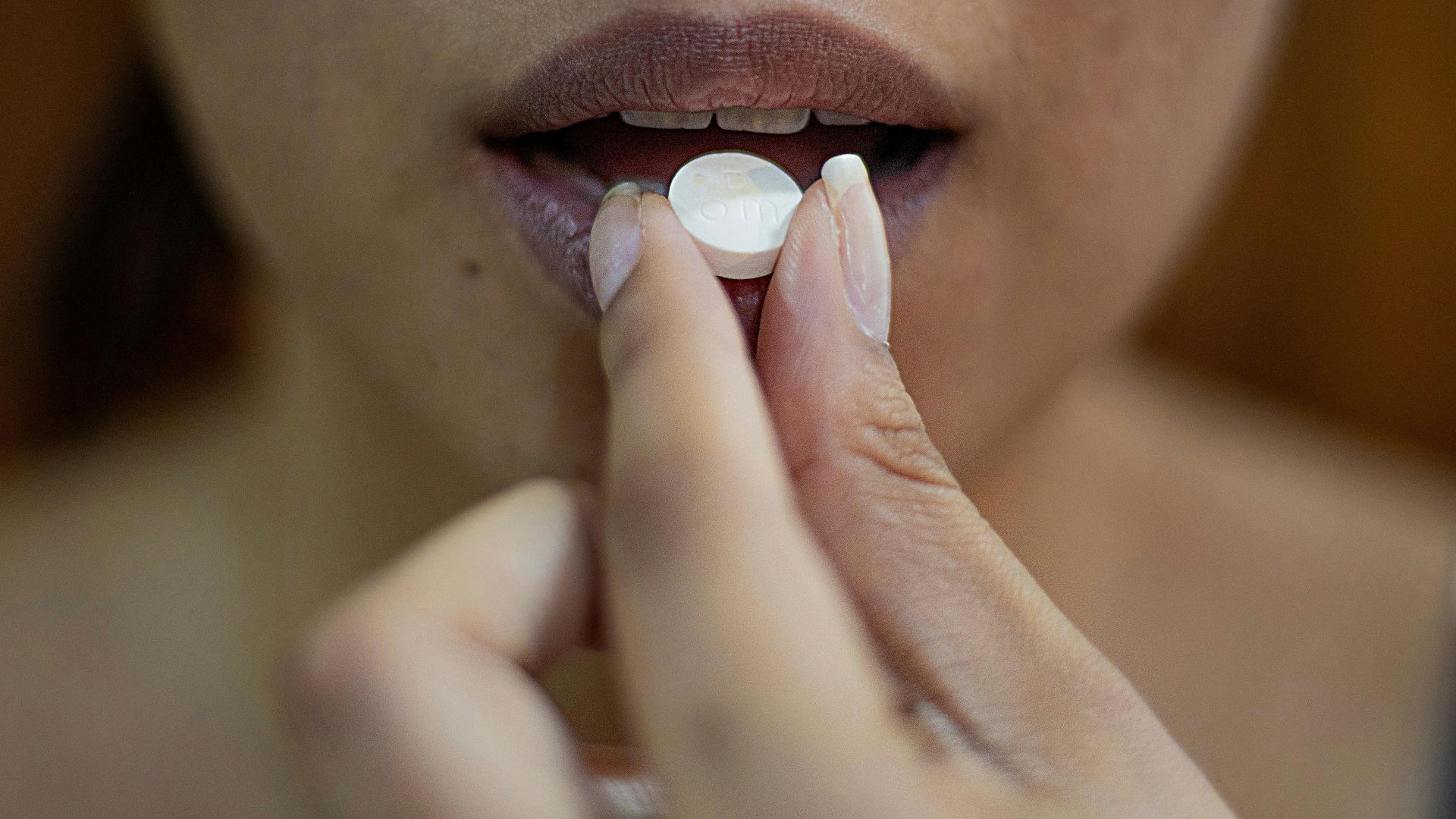 woman putting her hand on her lips