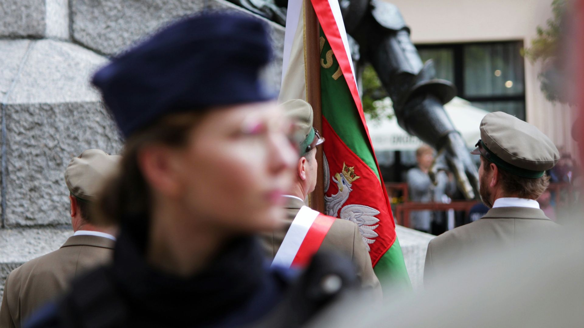 a group of people standing next to a statue