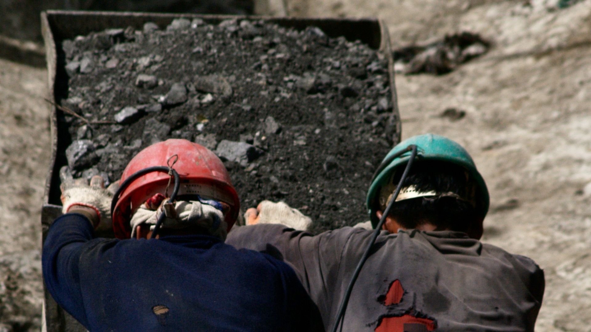 2 men in blue jacket wearing helmet