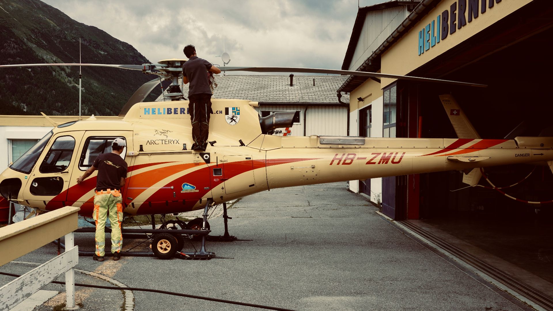 woman in red and white dress standing beside yellow and red airplane during daytime