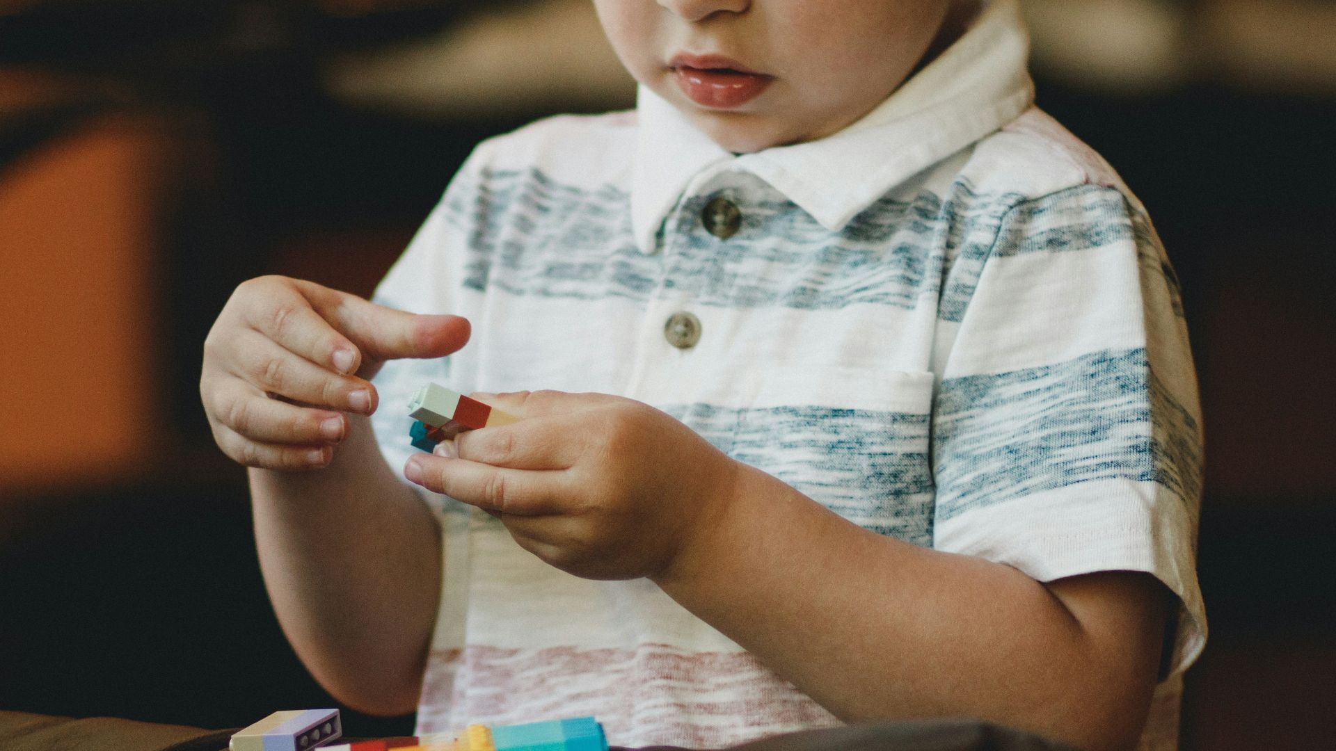 boy holding block toy