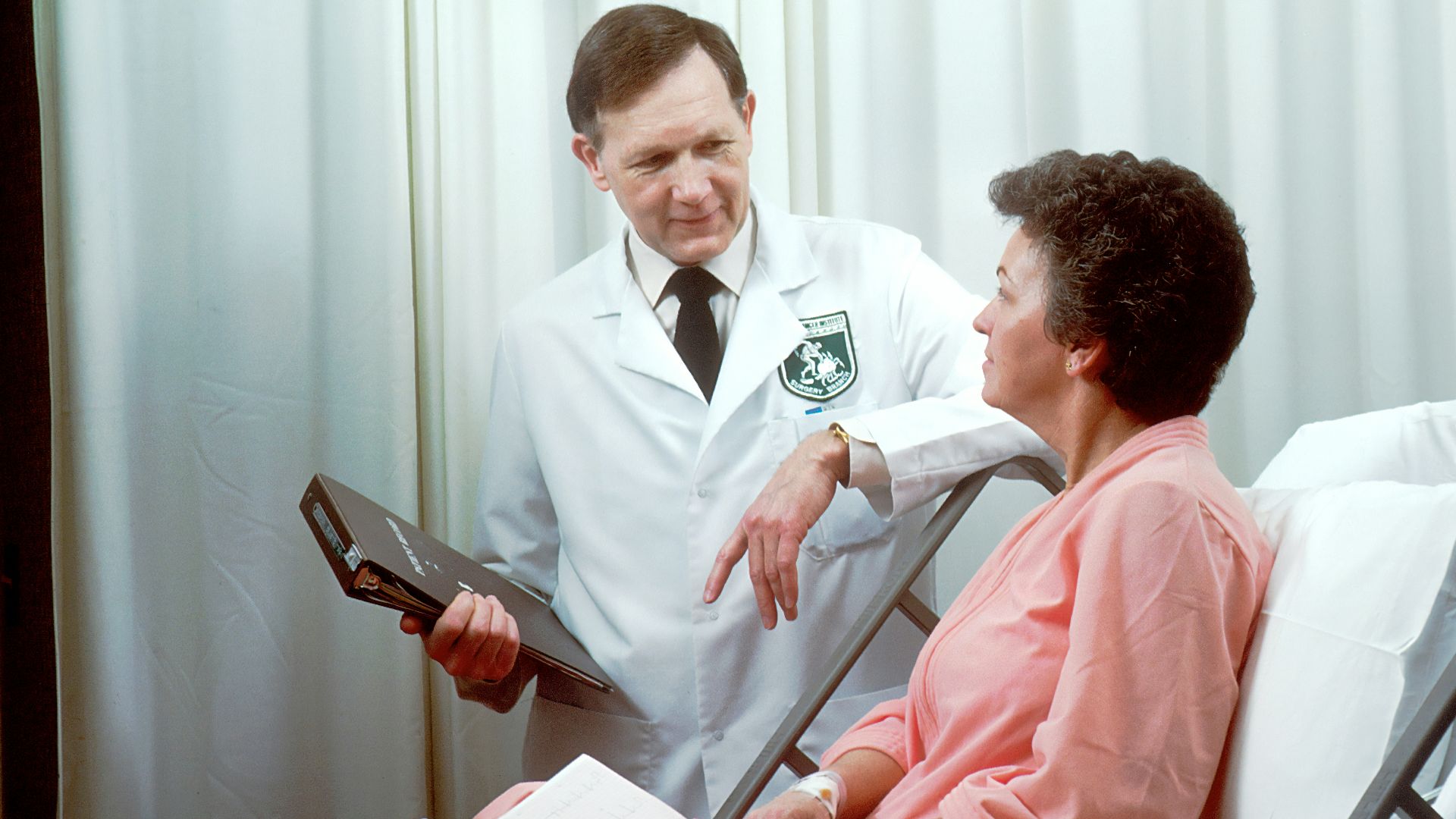 man in white button up shirt holding black tablet computer