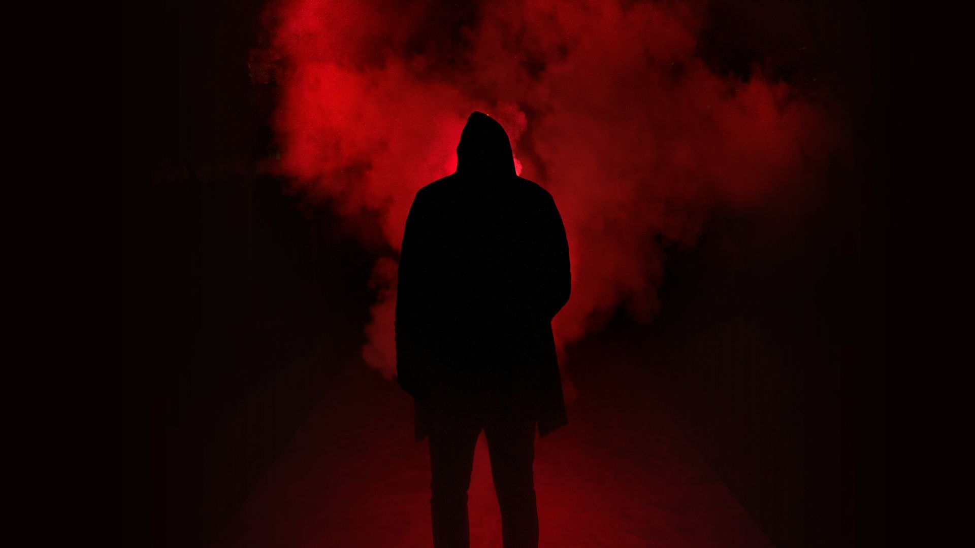 silhouette of person on a dark place with smoke