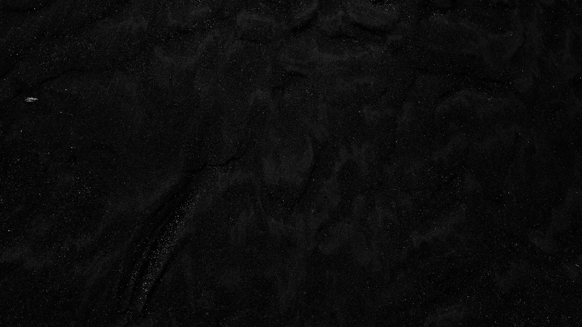 a black and white photo of water and sand