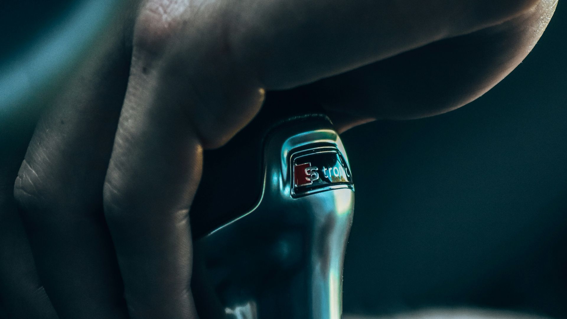 a close up of a person's hand holding a hair dryer