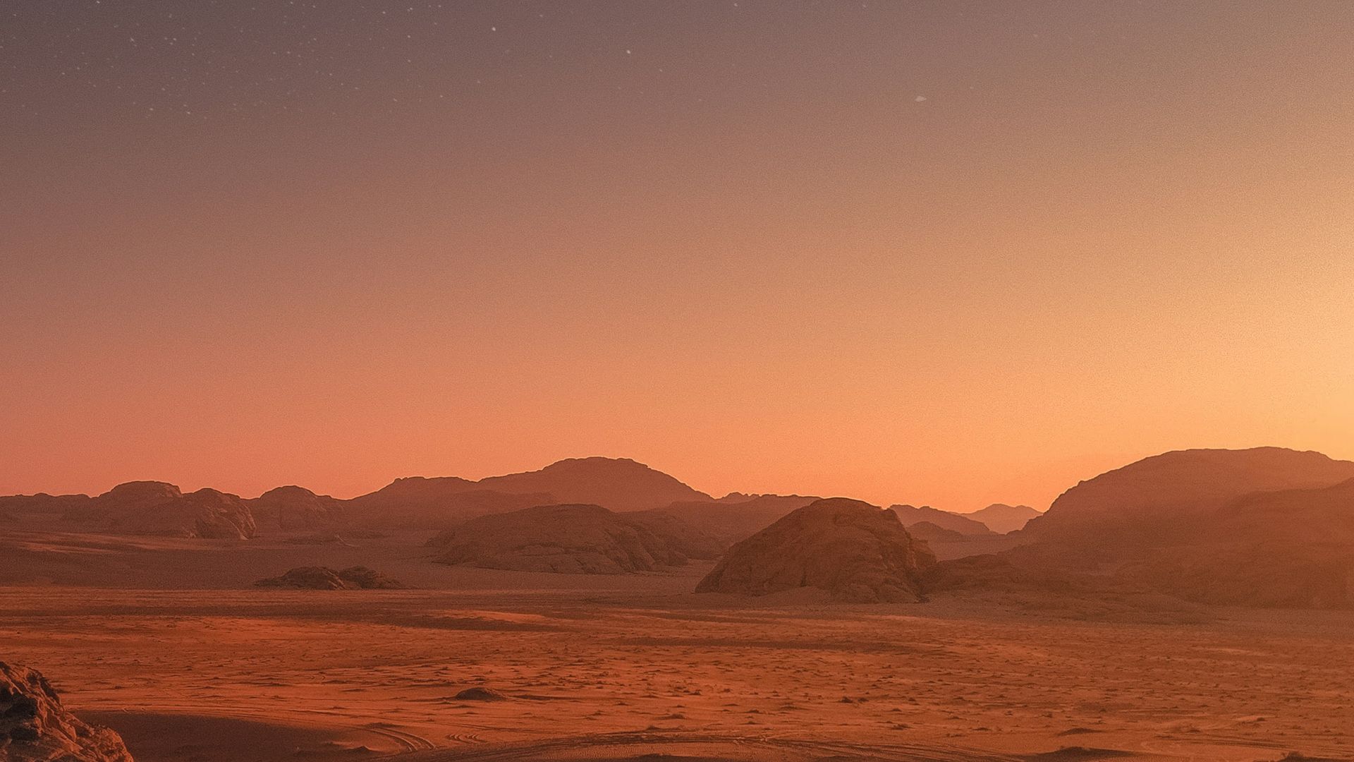 brown sand under blue sky during night time