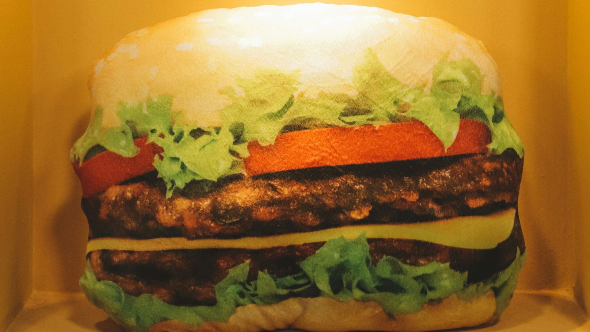 burger displayed on yellow container