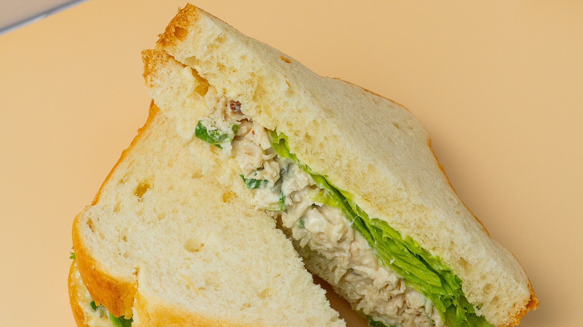 Chicken salad sandwich with lettuce on white bread