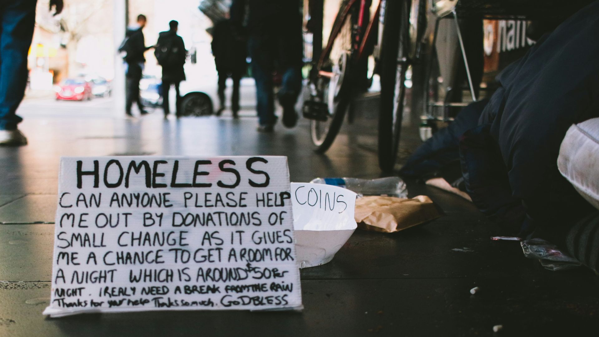 people walking on pathway and banner on ground
