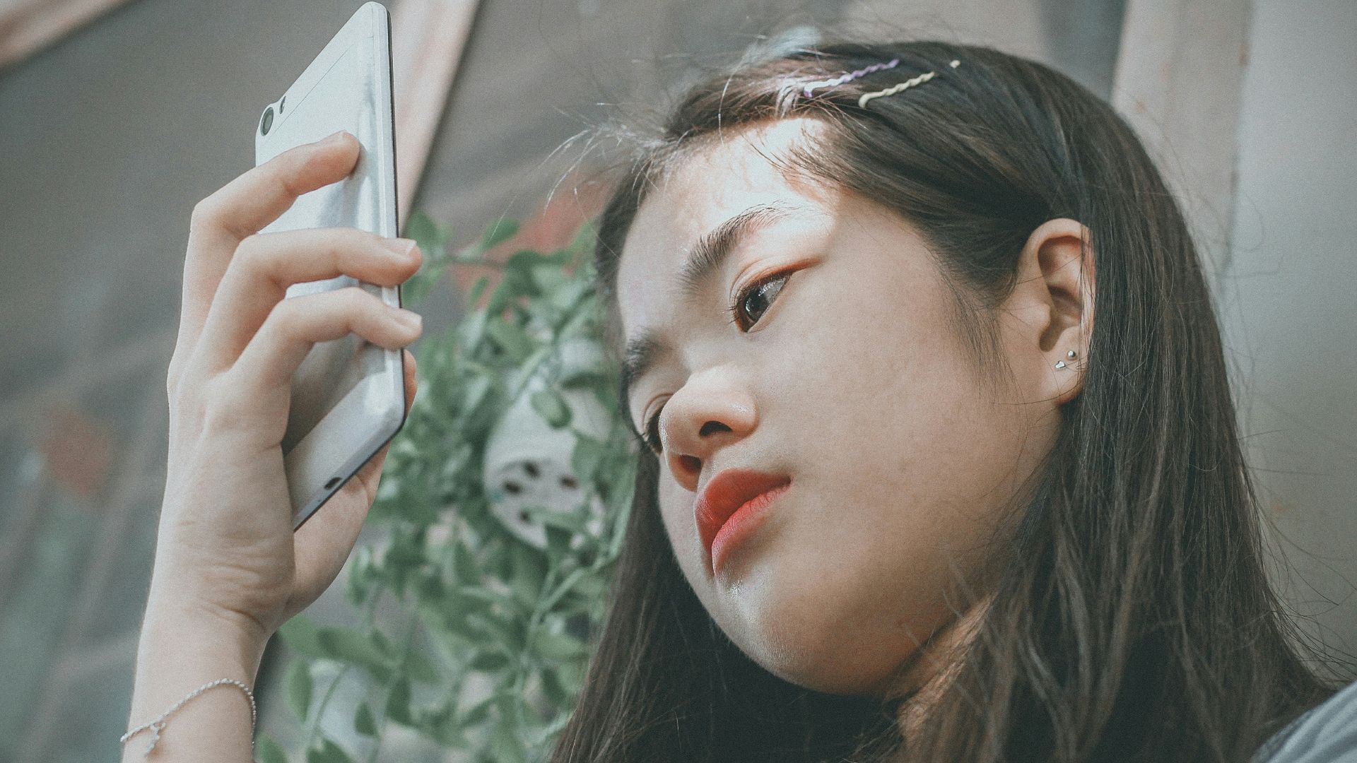 woman holding smartphone outside