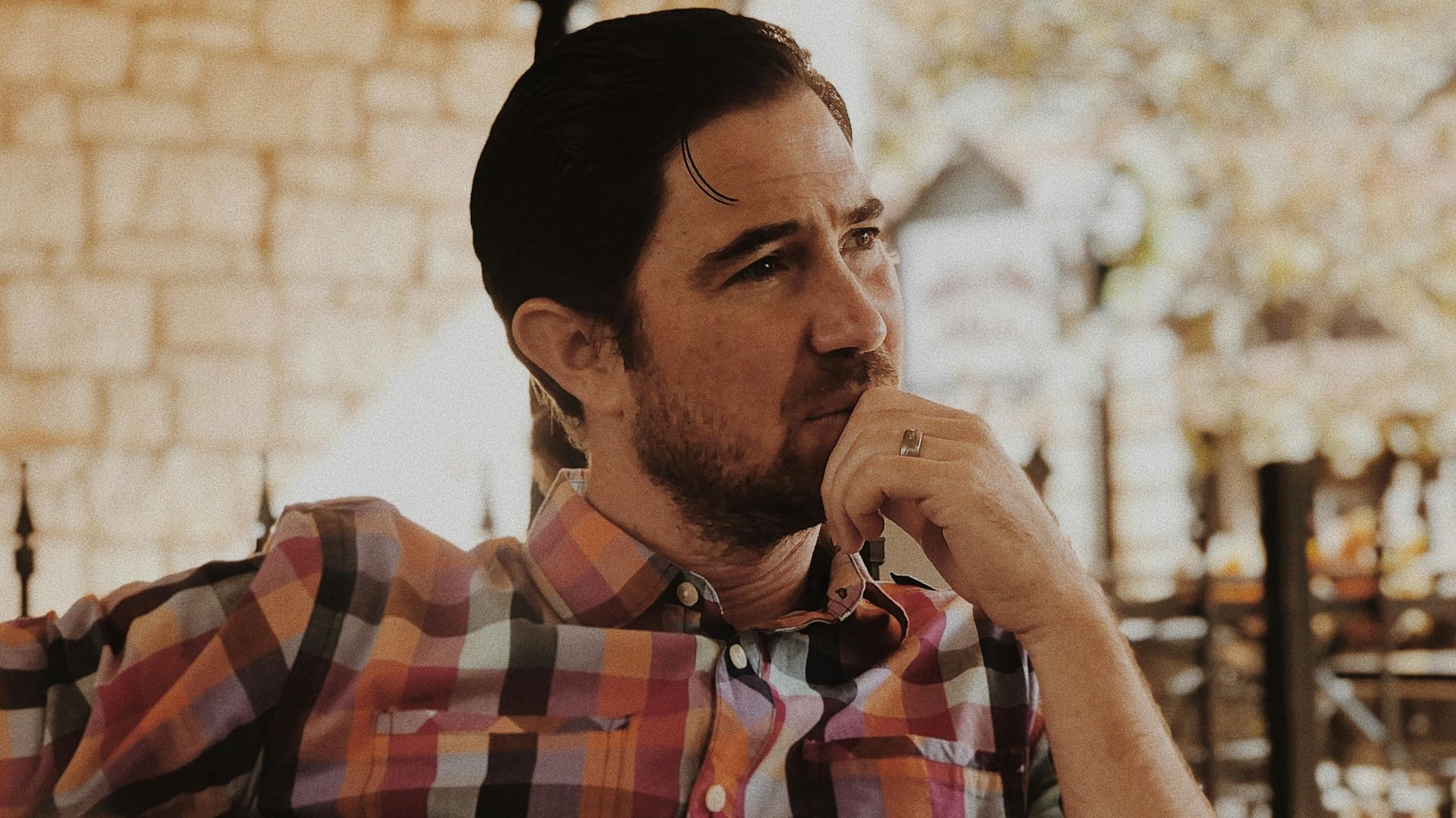 man in red and black plaid dress shirt