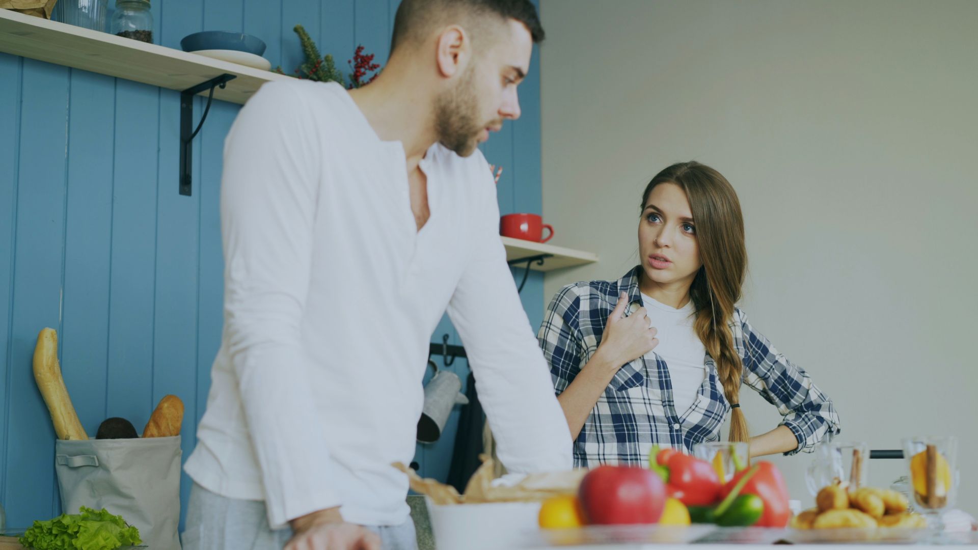 Couple arguing in a kitchen