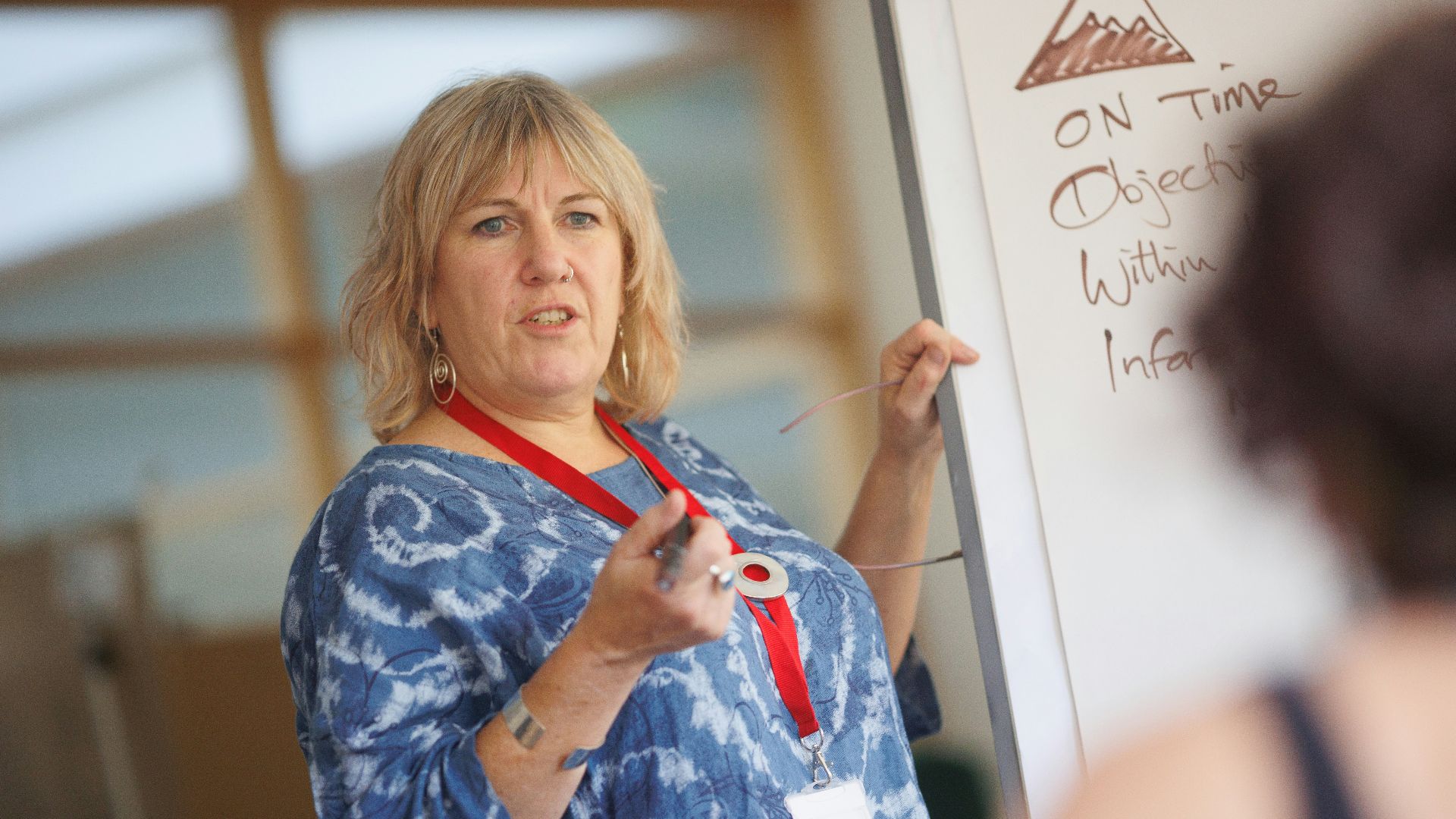 a person writing on a whiteboard