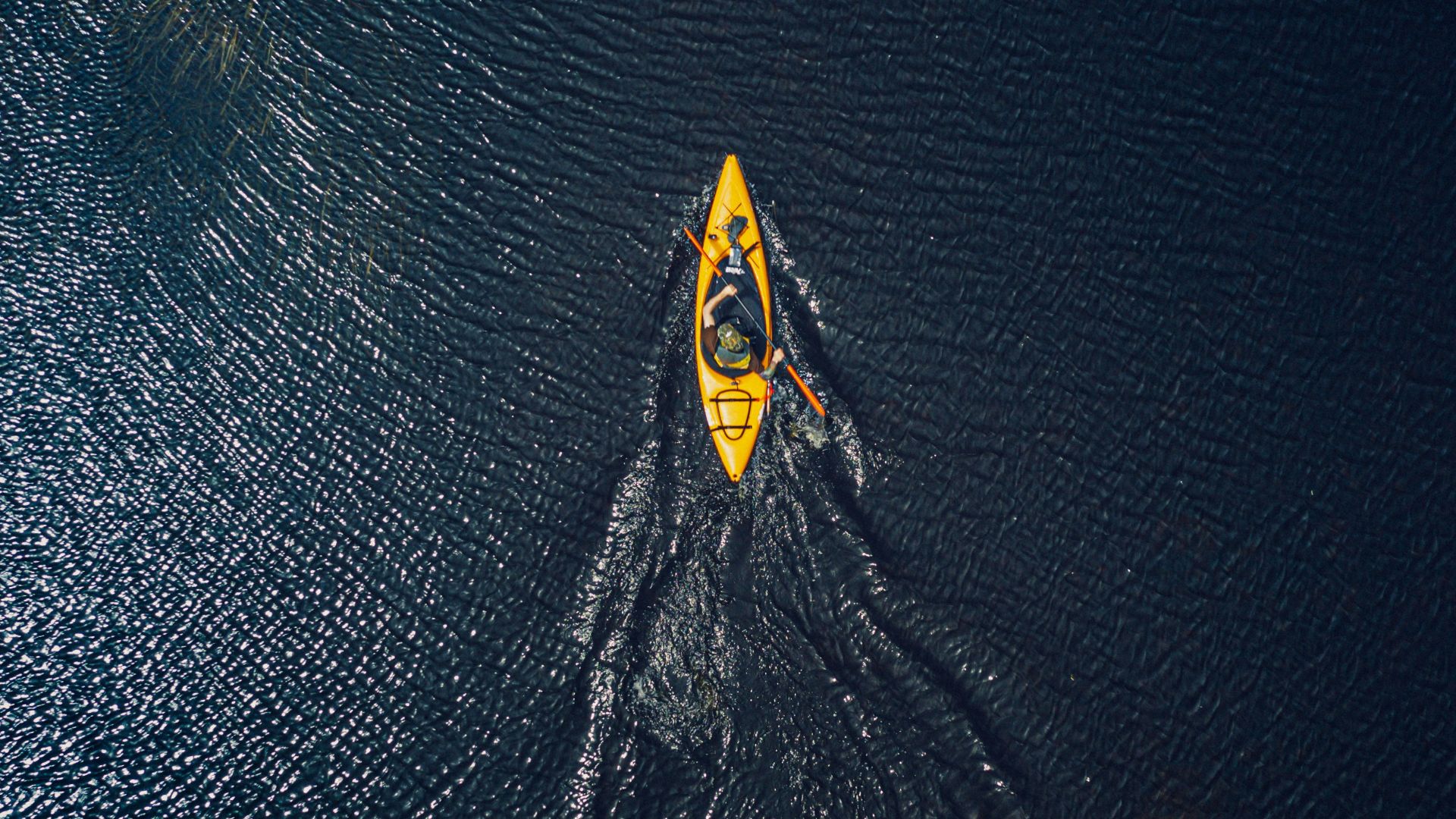 yellow and black surfboard on body of water