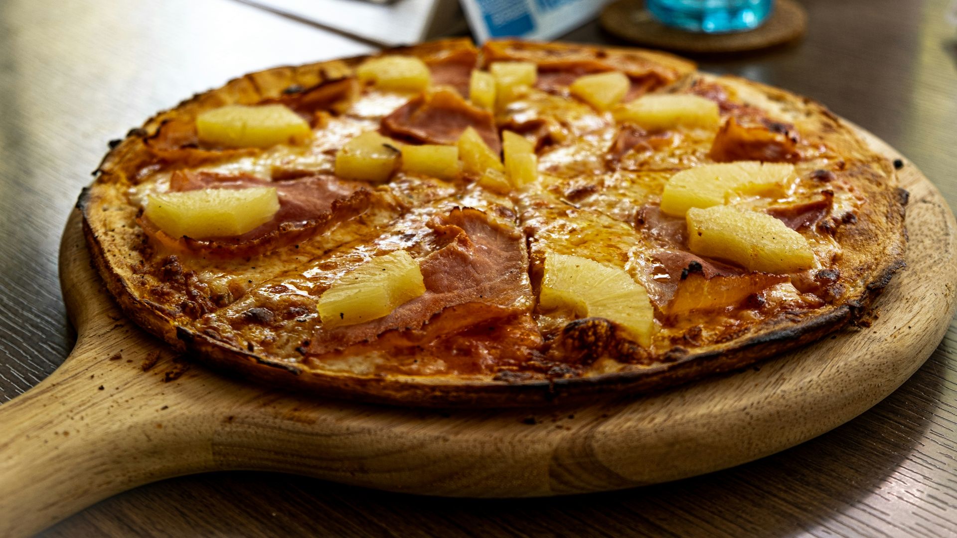 pizza on brown wooden round tray