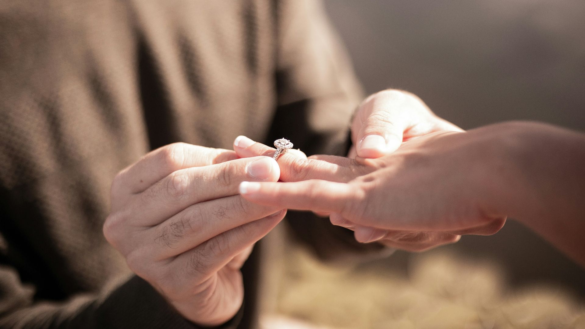 person holding silver diamond ring