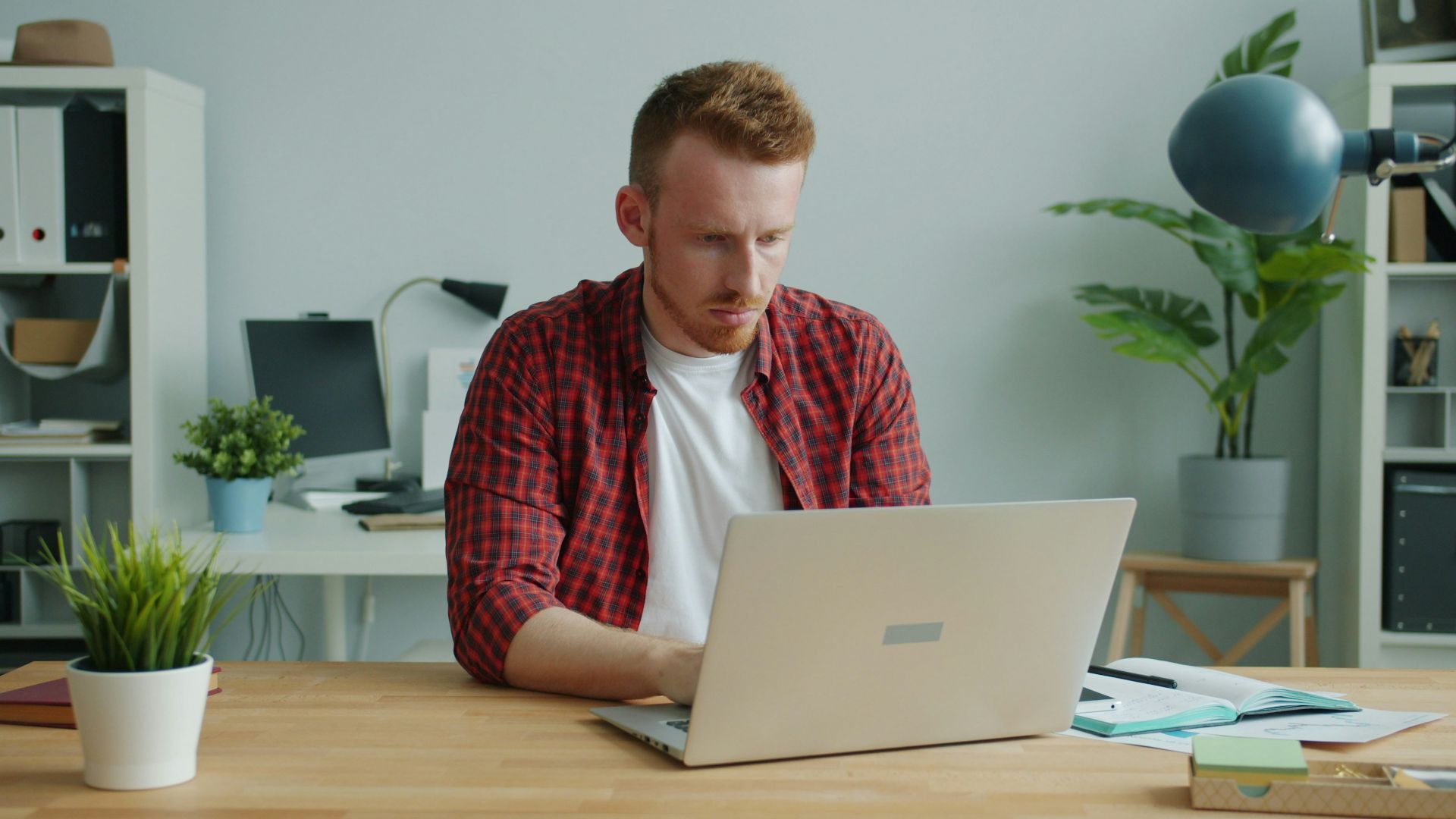 Man working on a laptop at a desk.