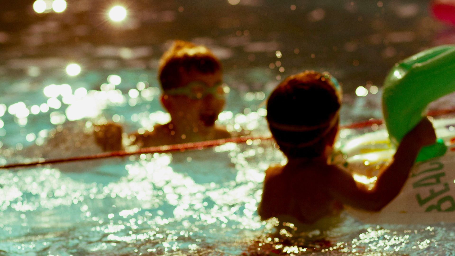 2 boys in swimming pool during daytime