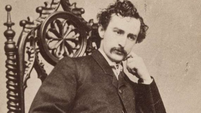 American actor John Wilkes Booth sitting on a chair