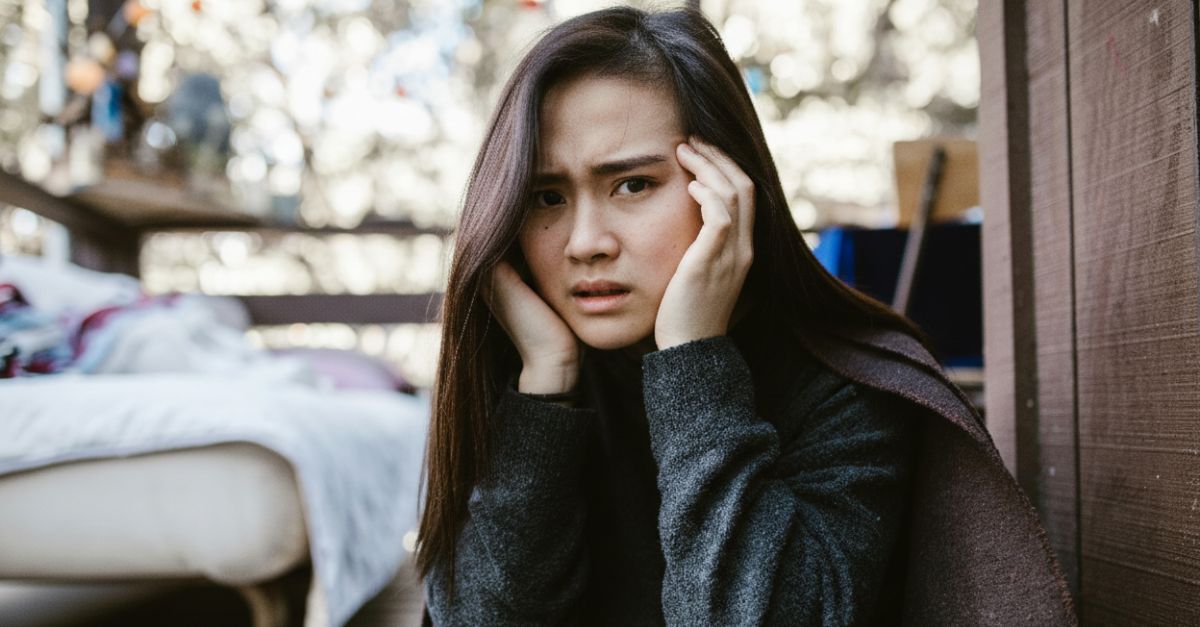 A Distressed Woman Holding her Head