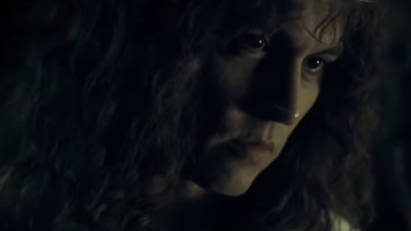 Screenshot: Johnny Deep with long hair wearing white shirt is looking at side - from The Libertine (2004)