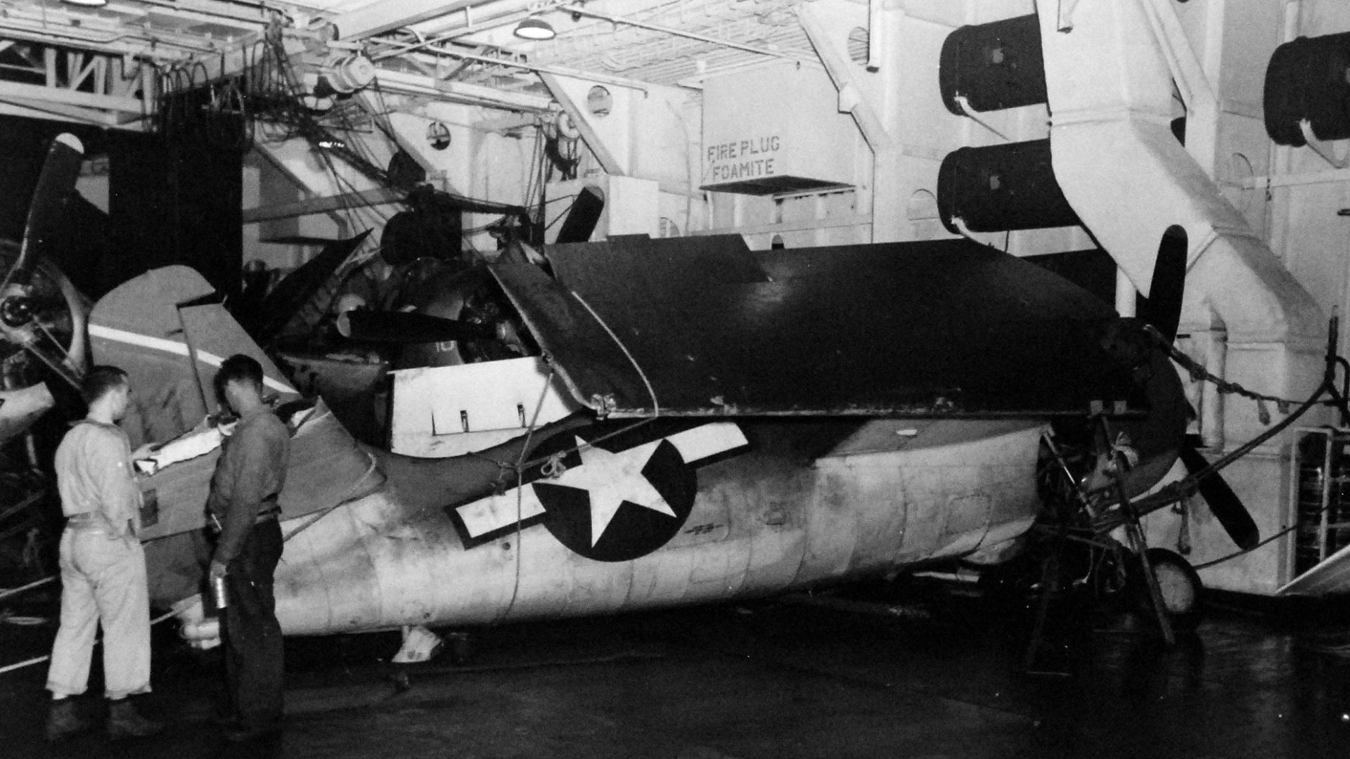 File:Damaged Wildcat within the hangar deck of Anzio (CVE-57) after Typhoon Cobra.jpg